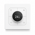 White four-button wall control with central rotary display on a clean white studio background