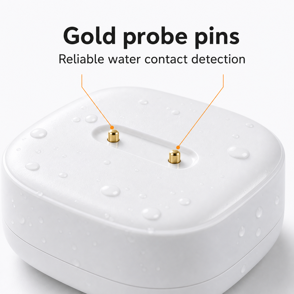 Close-up detail of gold probe pins on white water leak sensor