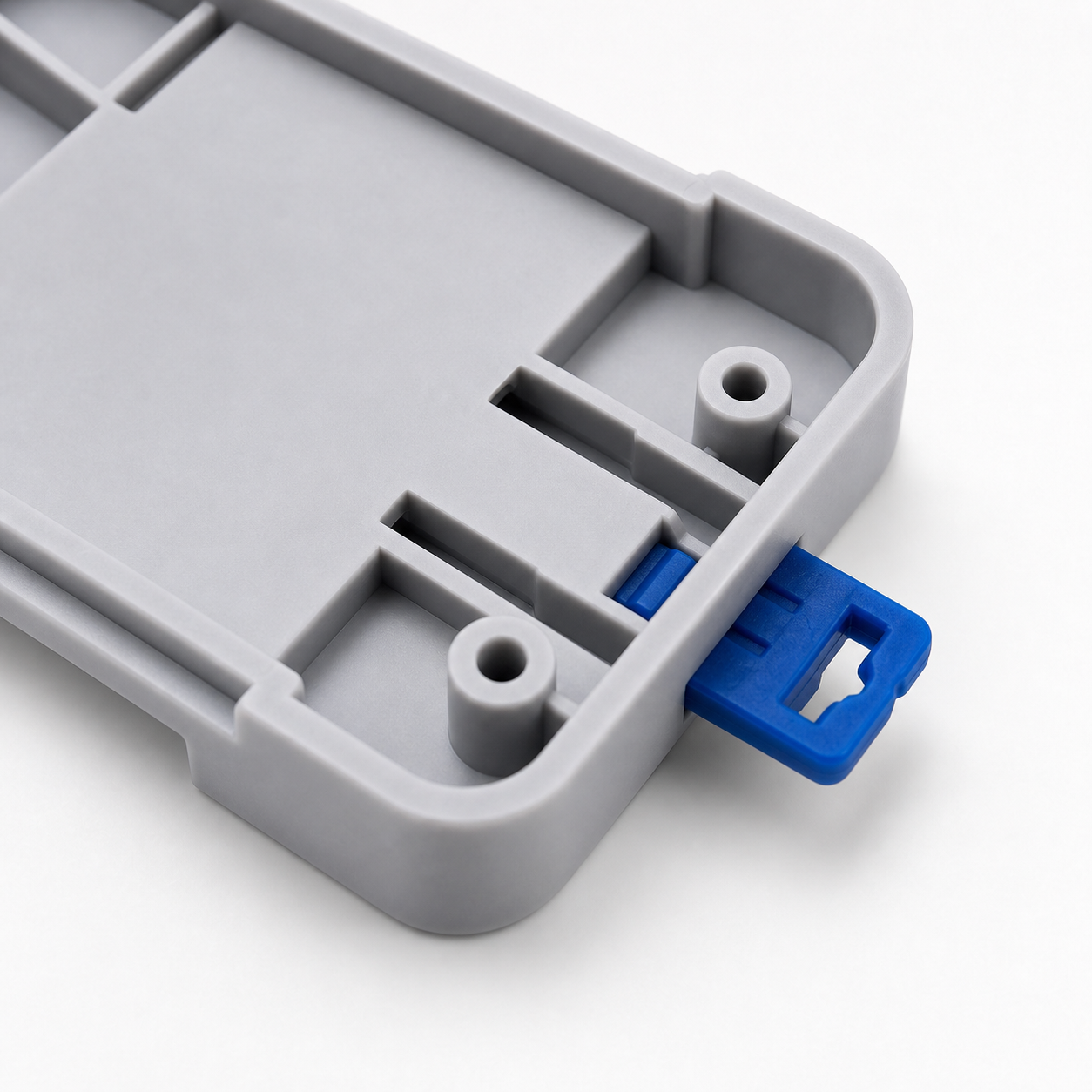 Close-up detail of DIN rail tray clip and blue release tab