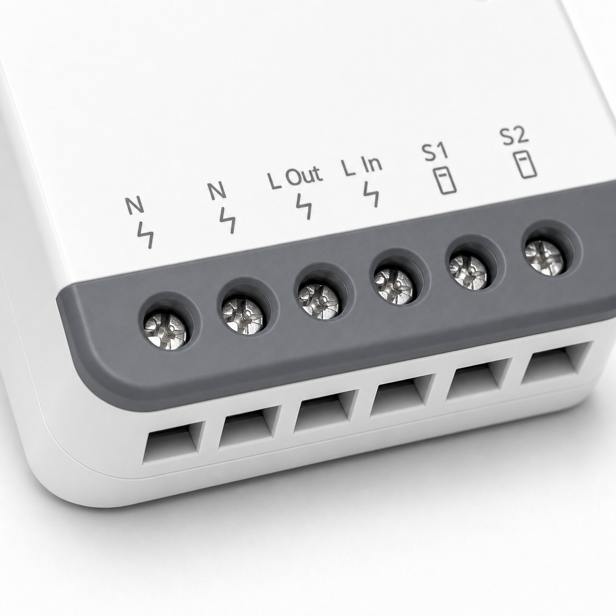 Macro detail of the gray terminal side on a compact Zigbee mini relay module
