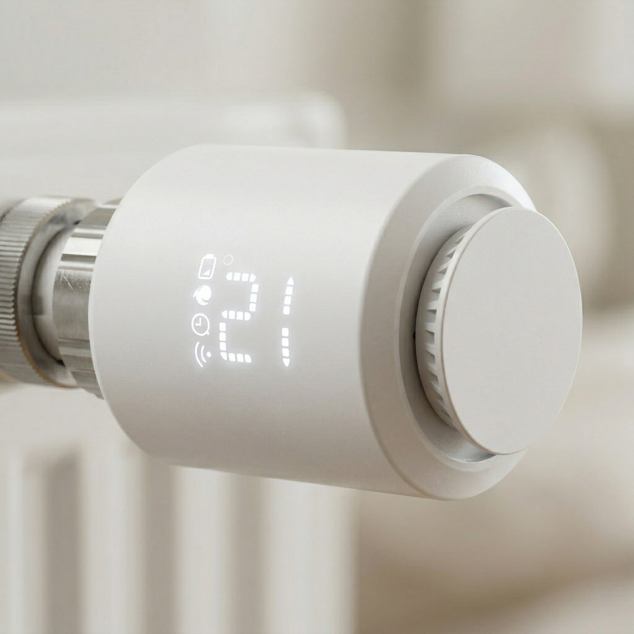 Détail d’une vanne thermostatique blanche installée sur radiateur.
